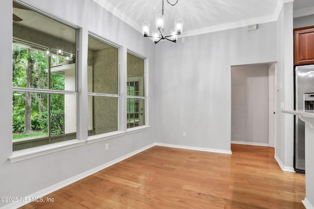 880 Buckeye Ln W, Saint Johns, FL 32259 - unfurnished dining area featuring a chandelier, light wood-type flooring, and crown molding