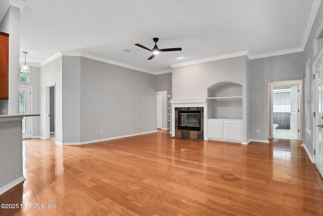 880 Buckeye Ln W, Saint Johns, FL 32259 - unfurnished living room featuring ceiling fan, light wood-type flooring, ornamental molding, a tile fireplace, and baseboards