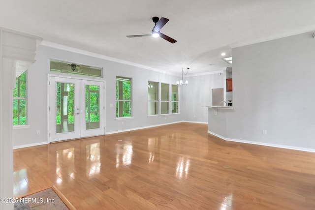 880 Buckeye Ln W, Saint Johns, FL 32259 - unfurnished living room featuring a chandelier, plenty of natural light, ornamental molding, baseboards, and ceiling fan