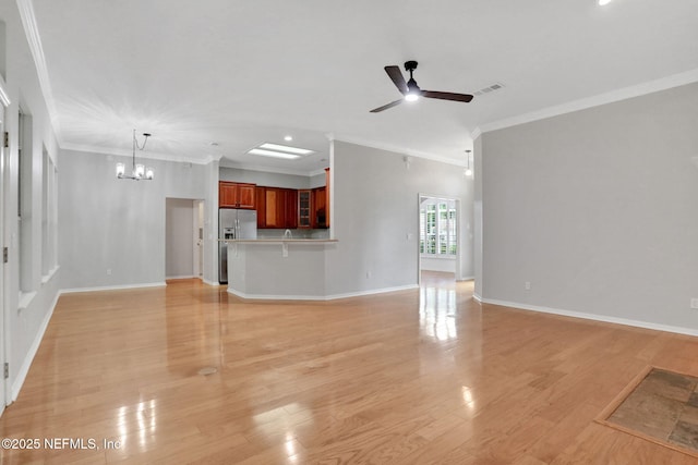 880 Buckeye Ln W, Saint Johns, FL 32259 - unfurnished living room with ornamental molding, a ceiling fan, a chandelier, and light wood finished floors