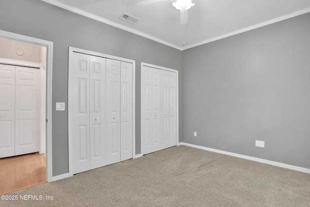 880 Buckeye Ln W, Saint Johns, FL 32259 - unfurnished bedroom with crown molding, carpet, multiple closets, baseboards, and ceiling fan