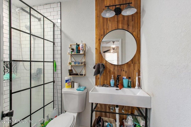 3020 Gilmore St, Jacksonville, FL 32205 - full bathroom with a shower stall, a textured wall, and a ceiling fan