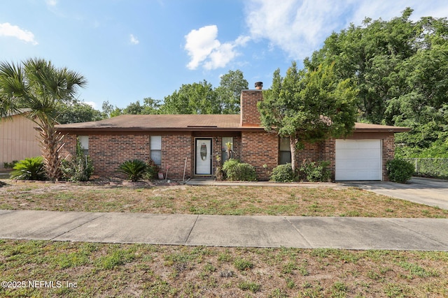 1247 Turtle Creek Dr N, Jacksonville, FL 32218 - view of front of property with an attached garage, driveway, brick siding, and a chimney