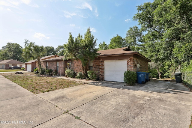 1247 Turtle Creek Dr N, Jacksonville, FL 32218 - view of front of house featuring brick siding, a garage, and driveway