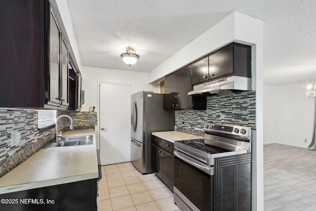 1247 Turtle Creek Dr N, Jacksonville, FL 32218 - kitchen featuring appliances with stainless steel finishes, under cabinet range hood, a sink, a textured ceiling, and decorative backsplash