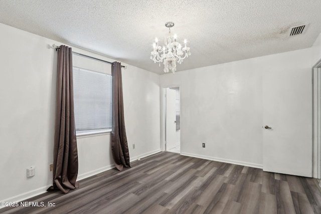 1247 Turtle Creek Dr N, Jacksonville, FL 32218 - unfurnished room featuring a chandelier, dark wood finished floors, a textured ceiling, and baseboards