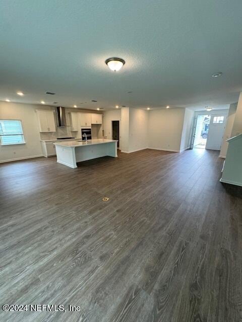 193 Silver Heron Way, Saint Augustine, FL 32092 - kitchen featuring open floor plan, white cabinets, light countertops, dark wood finished floors, and an island with sink