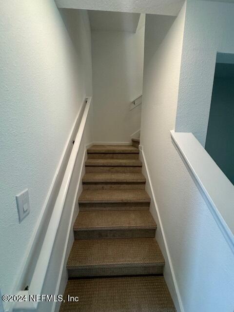 193 Silver Heron Way, Saint Augustine, FL 32092 - stairs featuring carpet, a textured wall, and baseboards