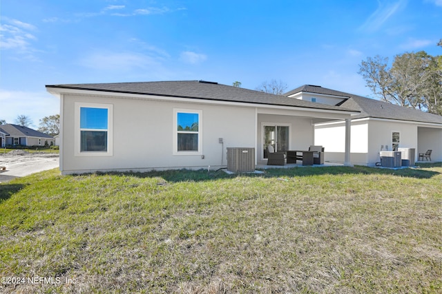 3369 Golden Eye Dr, Orange Park, FL 32065 - rear view of property featuring central AC, a yard, stucco siding, and an outdoor hangout area