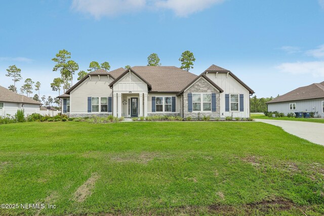 36461 Shortleaf Ave, Hilliard, FL 32046 - view of front facade with board and batten siding, stone siding, and a front yard