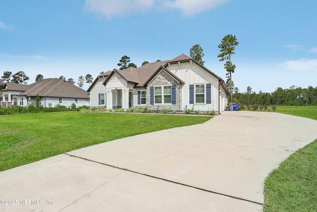 36461 Shortleaf Ave, Hilliard, FL 32046 - view of front of house featuring board and batten siding, stone siding, and a front lawn