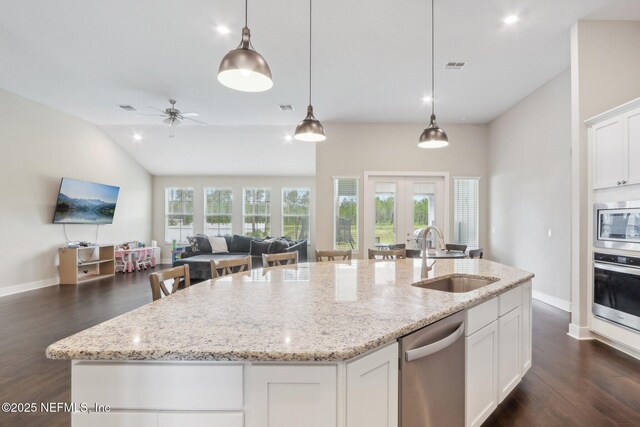 36461 Shortleaf Ave, Hilliard, FL 32046 - kitchen with a sink, appliances with stainless steel finishes, open floor plan, dark wood-style floors, and a kitchen island with sink