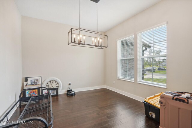 36461 Shortleaf Ave, Hilliard, FL 32046 - unfurnished room with healthy amount of natural light, a chandelier, dark wood-style flooring, and baseboards