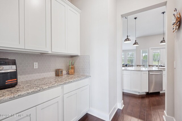 36461 Shortleaf Ave, Hilliard, FL 32046 - kitchen featuring dishwasher, backsplash, dark wood finished floors, and white cabinets