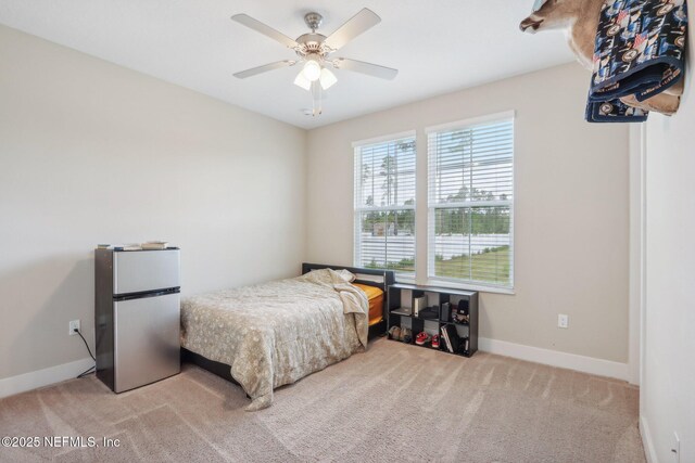 36461 Shortleaf Ave, Hilliard, FL 32046 - bedroom with freestanding refrigerator, baseboards, carpet floors, and ceiling fan