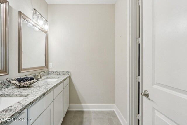 36461 Shortleaf Ave, Hilliard, FL 32046 - bathroom featuring baseboards, double vanity, and tile patterned flooring