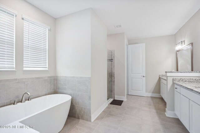 36461 Shortleaf Ave, Hilliard, FL 32046 - full bathroom with vanity, a freestanding tub, and a shower stall