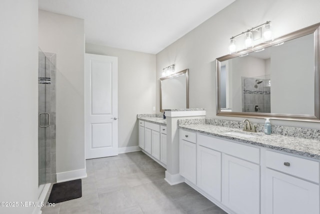 36461 Shortleaf Ave, Hilliard, FL 32046 - bathroom with a stall shower, two vanities, and baseboards