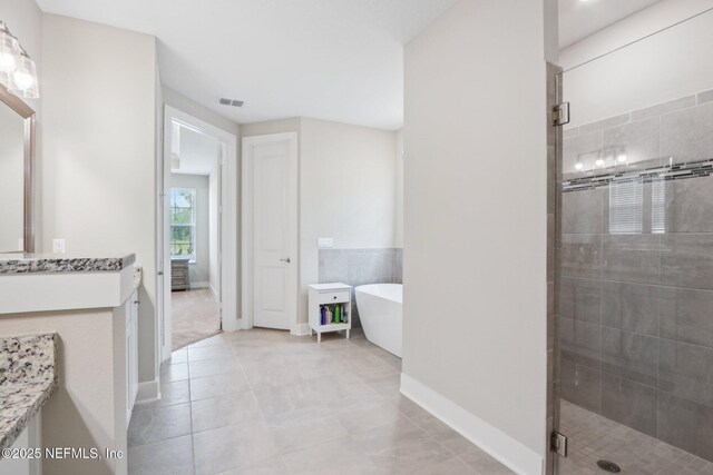 36461 Shortleaf Ave, Hilliard, FL 32046 - bathroom featuring vanity, a shower stall, a freestanding tub, and tile patterned floors