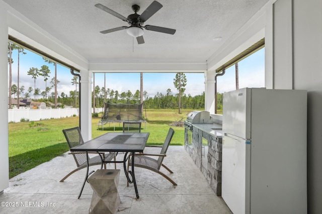 36461 Shortleaf Ave, Hilliard, FL 32046 - sunroom with an outdoor kitchen, outdoor dining space, and a ceiling fan
