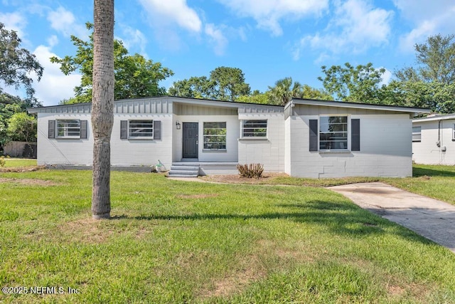 6903 Mayapple Rd, Jacksonville, FL 32211 - view of front of home with a front lawn