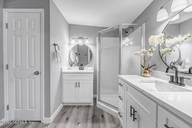 6903 Mayapple Rd, Jacksonville, FL 32211 - full bathroom featuring a stall shower, wood finished floors, and two vanities
