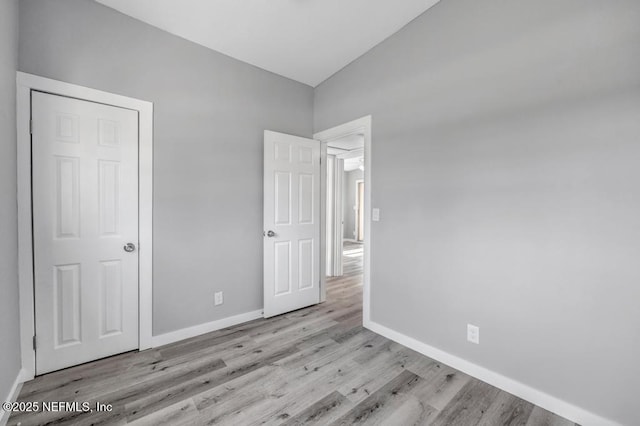 6903 Mayapple Rd, Jacksonville, FL 32211 - unfurnished bedroom featuring wood finished floors and vaulted ceiling