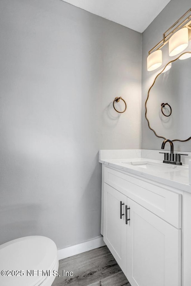 6903 Mayapple Rd, Jacksonville, FL 32211 - half bath featuring vanity and wood finished floors