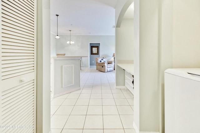 535 Florida Club Blvd Unit 307, Saint Augustine, FL 32084 - corridor featuring light tile patterned floors, washer / dryer, arched walkways, and baseboards