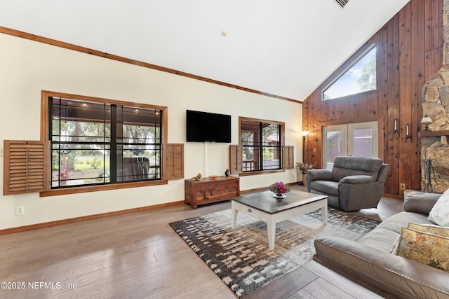 156 County Road 13, Saint Augustine, FL 32092 - living room with high vaulted ceiling, wood finished floors, baseboards, and wooden walls