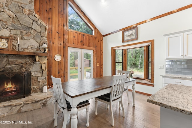 156 County Road 13, Saint Augustine, FL 32092 - dining room with healthy amount of natural light, light wood finished floors, baseboards, a fireplace, and wooden walls