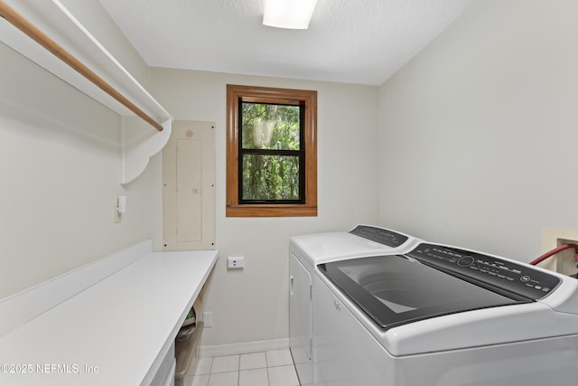 156 County Road 13, Saint Augustine, FL 32092 - laundry room with washing machine and clothes dryer, electric panel, light tile patterned floors, a textured ceiling, and baseboards