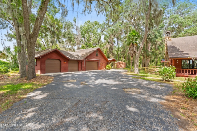 156 County Road 13, Saint Augustine, FL 32092 - view of front of home featuring a detached garage, an outdoor structure, and a chimney