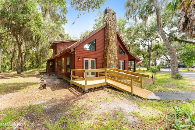 156 County Road 13, Saint Augustine, FL 32092 - view of home's exterior with french doors, a wooden deck, and a chimney