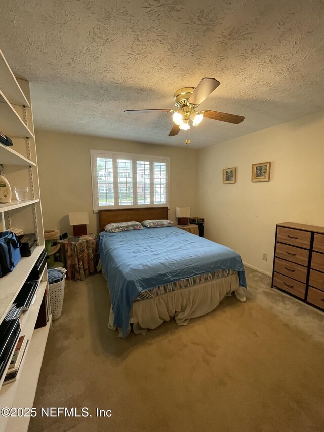 4915 Baymeadows Rd Unit 11E, Jacksonville, FL 32217 - carpeted bedroom featuring a textured ceiling and ceiling fan