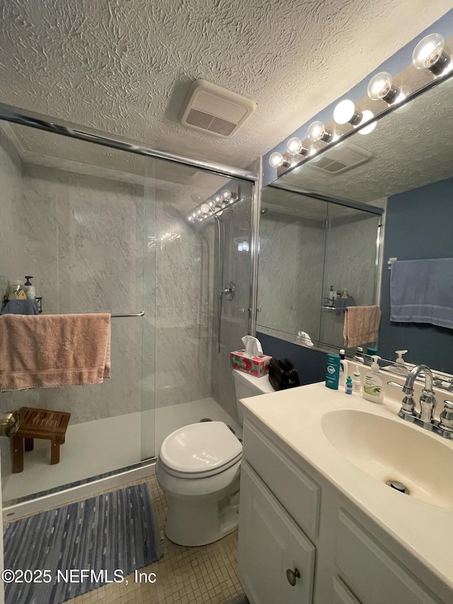 4915 Baymeadows Rd Unit 11E, Jacksonville, FL 32217 - full bathroom with vanity, a shower stall, tile patterned flooring, and a textured ceiling