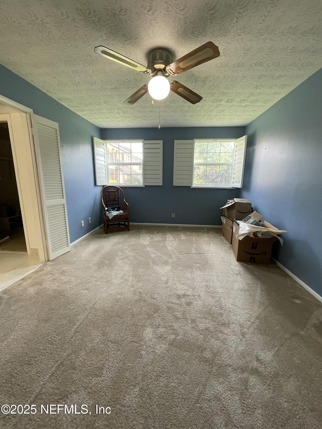 4915 Baymeadows Rd Unit 11E, Jacksonville, FL 32217 - unfurnished room featuring a textured ceiling, carpet, ceiling fan, and plenty of natural light
