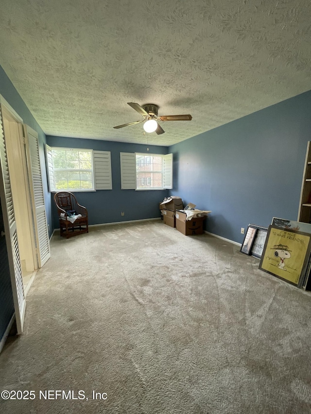 4915 Baymeadows Rd Unit 11E, Jacksonville, FL 32217 - unfurnished bedroom with a textured ceiling, carpet, and ceiling fan