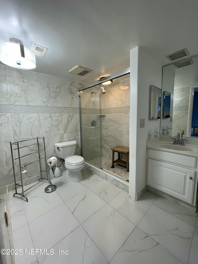 4915 Baymeadows Rd Unit 11E, Jacksonville, FL 32217 - full bath featuring marble look tiles, a shower stall, vanity, and tile walls