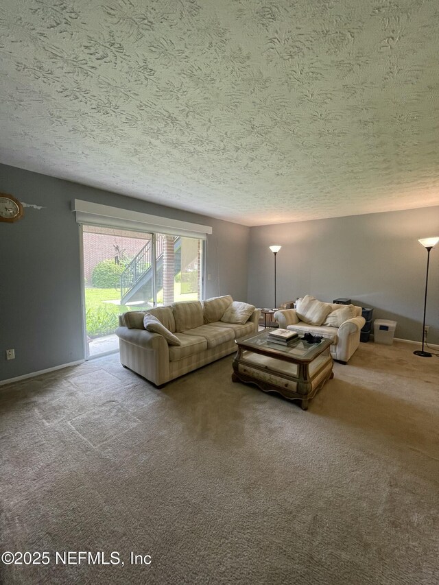 4915 Baymeadows Rd Unit 11E, Jacksonville, FL 32217 - carpeted living area with a textured ceiling