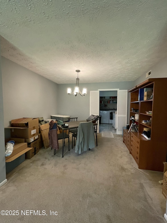 4915 Baymeadows Rd Unit 11E, Jacksonville, FL 32217 - dining space featuring light colored carpet, a chandelier, and a textured ceiling