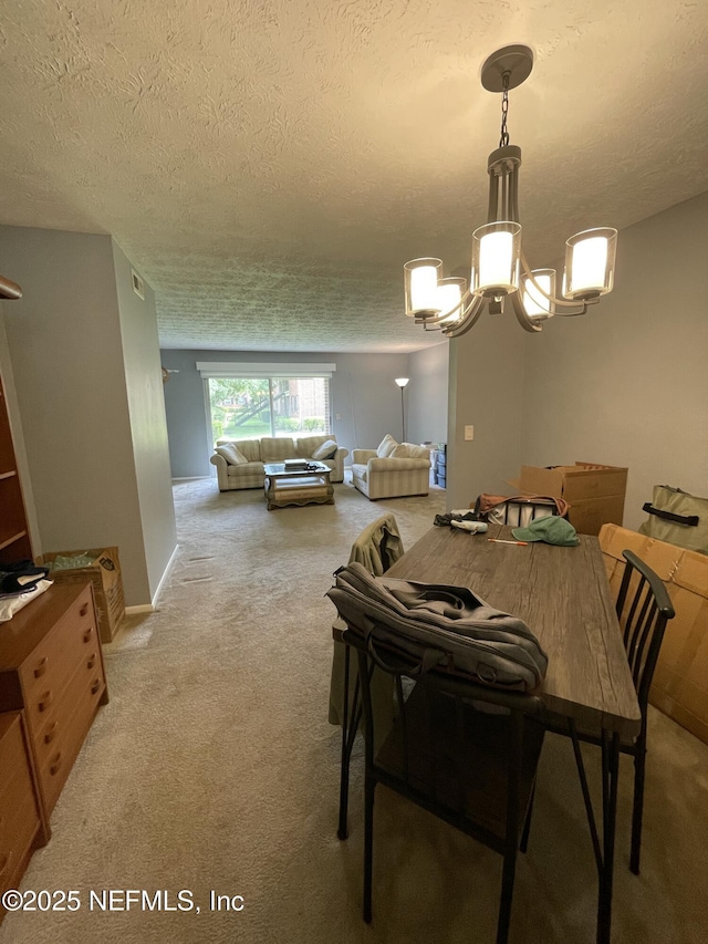 4915 Baymeadows Rd Unit 11E, Jacksonville, FL 32217 - carpeted dining room with a chandelier and a textured ceiling