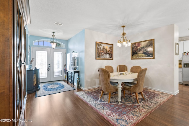 85464 Amaryllis Ct, Fernandina Beach, FL 32034 - dining room with wood finished floors, baseboards, french doors, and a chandelier