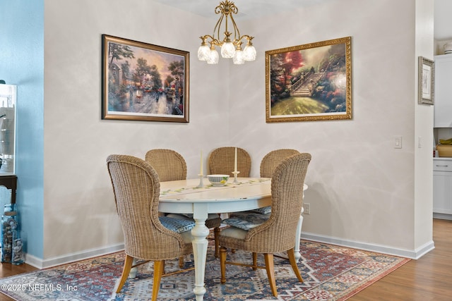 85464 Amaryllis Ct, Fernandina Beach, FL 32034 - dining space featuring a chandelier, wood finished floors, and baseboards