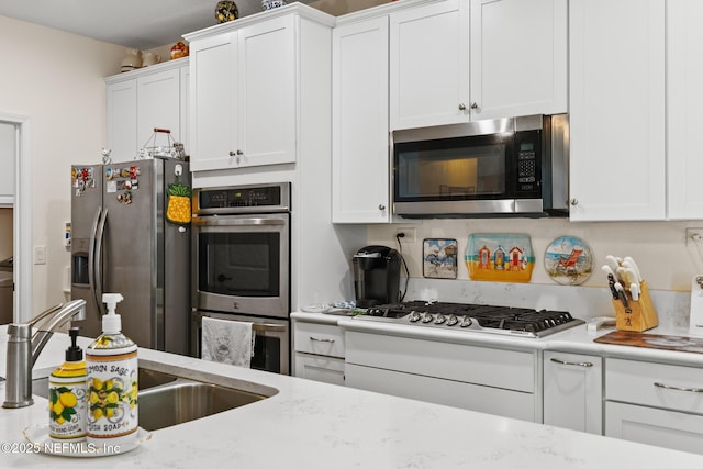 85464 Amaryllis Ct, Fernandina Beach, FL 32034 - kitchen with appliances with stainless steel finishes, a sink, and white cabinets