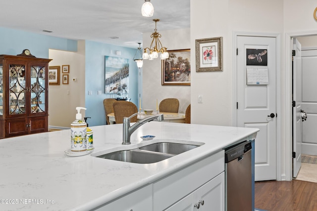 85464 Amaryllis Ct, Fernandina Beach, FL 32034 - kitchen with dishwasher, a sink, hanging light fixtures, a chandelier, and white cabinetry