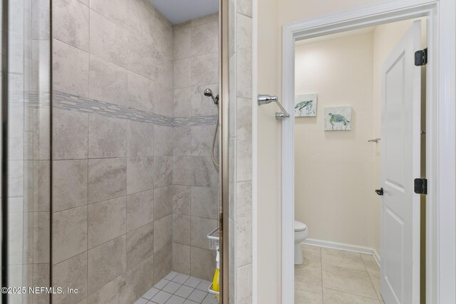 85464 Amaryllis Ct, Fernandina Beach, FL 32034 - bathroom with toilet, tiled shower, baseboards, and tile patterned floors