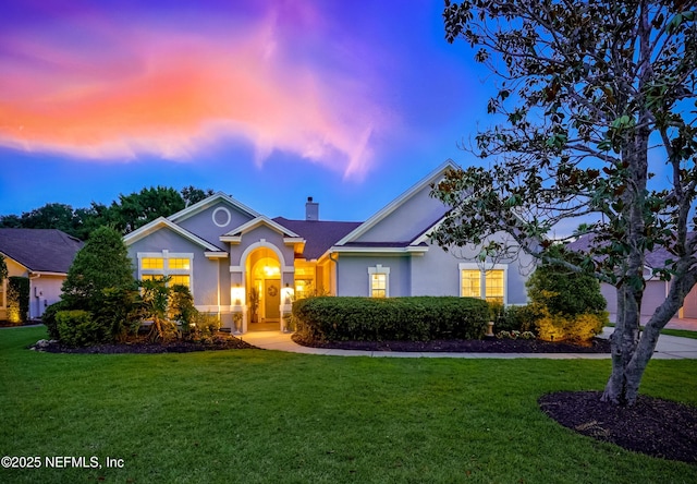 828 Lotus Ln N, Saint Johns, FL 32259 - traditional-style house with a front lawn, a chimney, and stucco siding