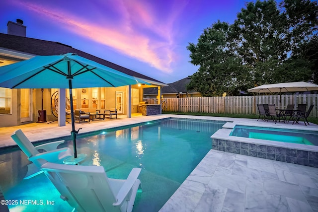 828 Lotus Ln N, Saint Johns, FL 32259 - pool at dusk with an in-ground hot tub, a patio, a fenced backyard, and an outdoor hangout area