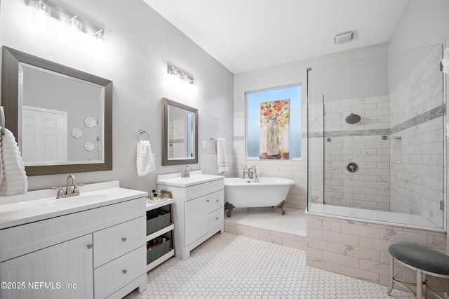 828 Lotus Ln N, Saint Johns, FL 32259 - bathroom featuring a soaking tub, two vanities, tiled shower, and tile patterned floors